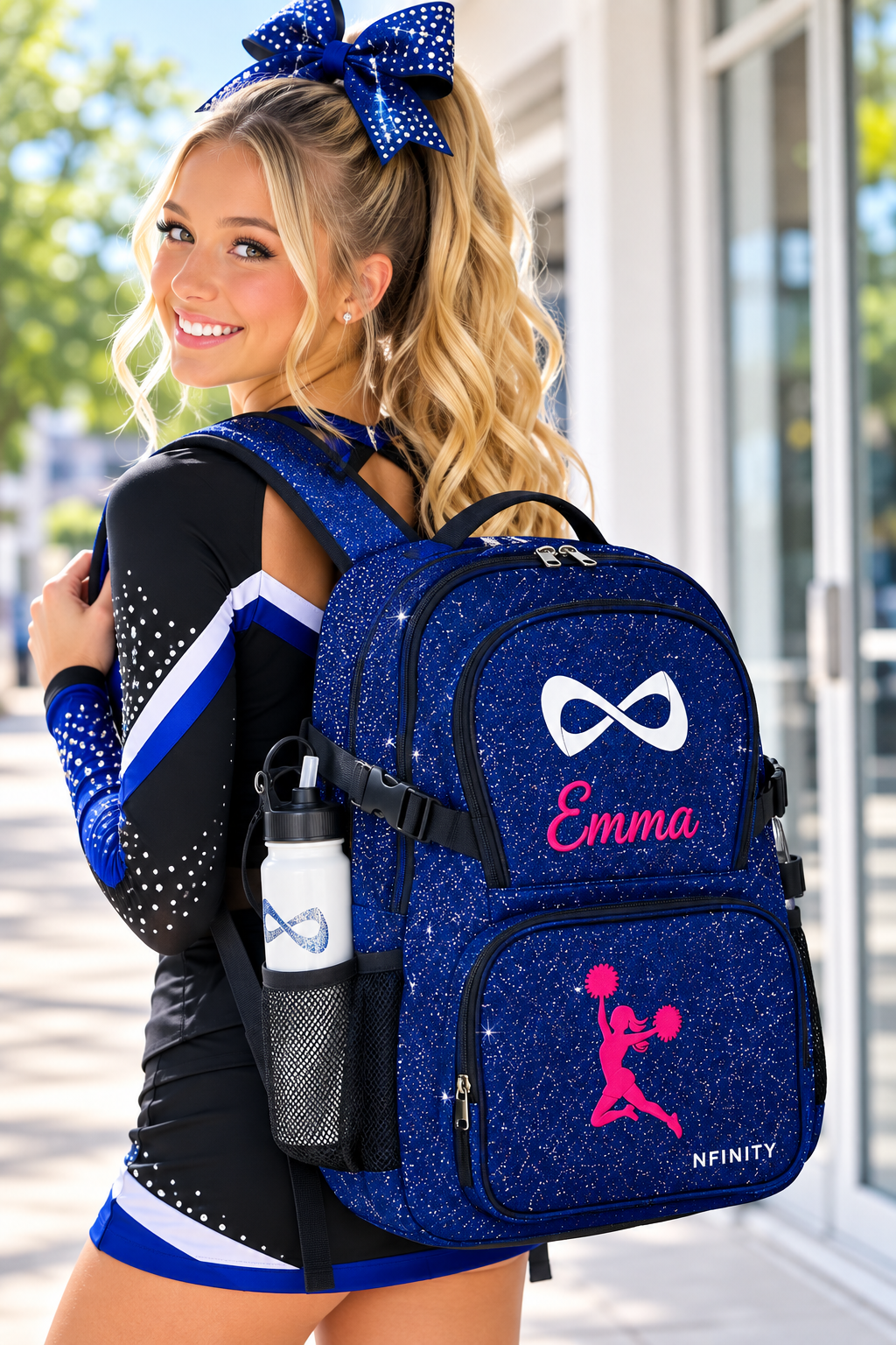 Teen cheerleader wearing a personalized royal blue Nfinity sparkle backpack.
