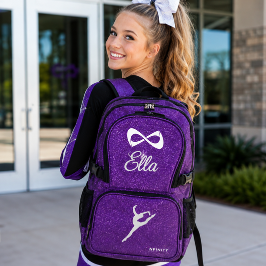 Teen cheerleader wearing a personalized purple glitter cheer backpack with embroidered name and design.