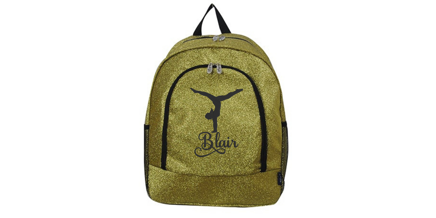 Gold glitter cheer backpack with black trim featuring a gymnast silhouette and custom name “Blair” on the front pocket