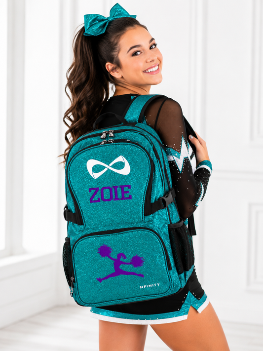 Teen cheerleader wearing a personalized teal Nfinity glitter backpack embroidered with a custom name and cheer design.