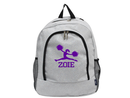 Silver glitter cheer backpack with purple cheerleader silhouette and custom name “Zoie” on the front pocket